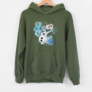 May include: A green hooded sweatshirt with a graphic print of Olaf the snowman from the movie Frozen. Olaf is smiling and surrounded by snowflakes.
