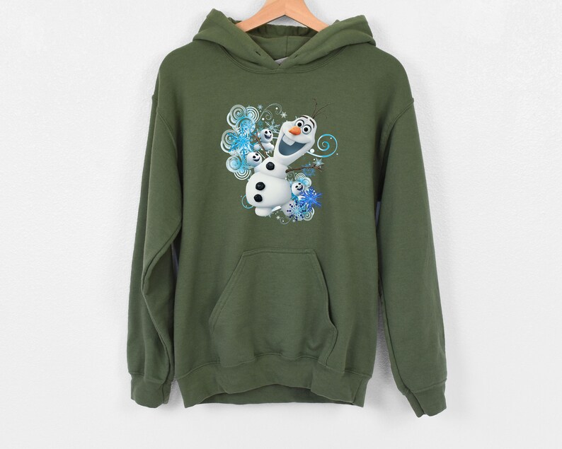May include: A green hooded sweatshirt with a graphic print of Olaf the snowman from the movie Frozen. Olaf is smiling and surrounded by snowflakes.