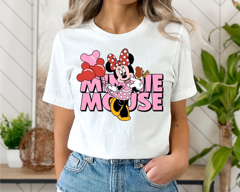 May include: White t-shirt with a pink and red Minnie Mouse graphic and the text "Minnie Mouse".