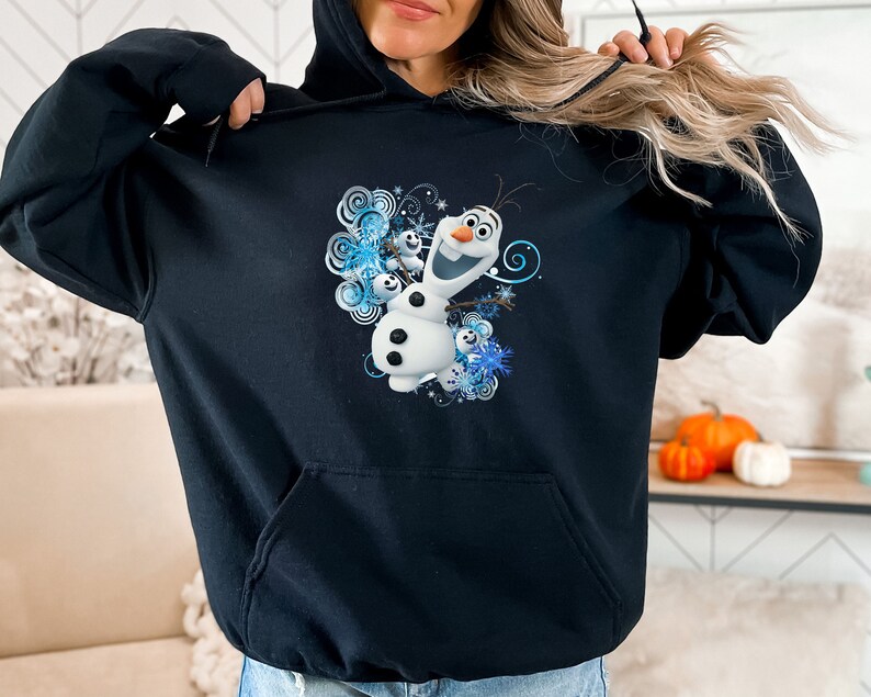May include: Black hoodie with a graphic print of Olaf from Frozen. The graphic features Olaf with a blue and white snowflake design.