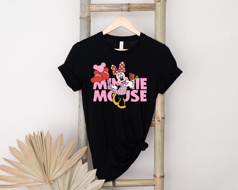 May include: Black t-shirt with a pink and red Minnie Mouse graphic and the text "MINNIE MOUSE" in pink letters.