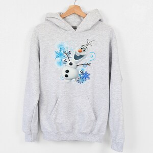 May include: A gray hooded sweatshirt with a graphic of Olaf from the movie Frozen. Olaf is smiling and surrounded by snowflakes.