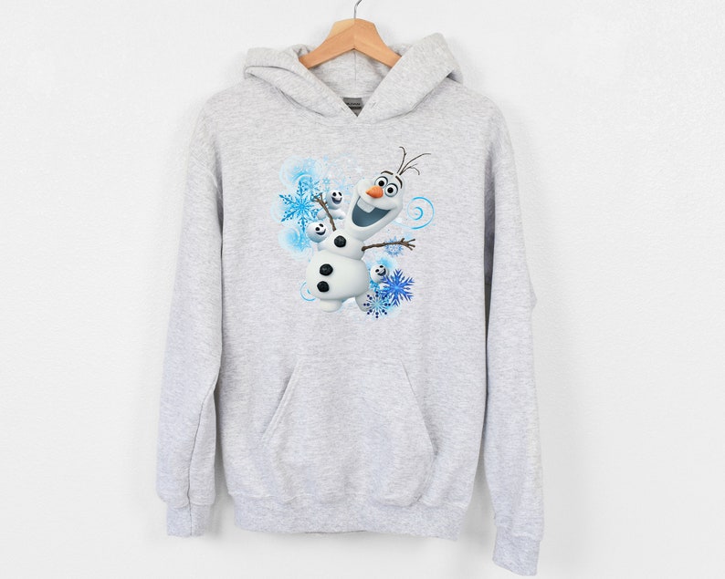 May include: A gray hooded sweatshirt with a graphic of Olaf from the movie Frozen. Olaf is smiling and surrounded by snowflakes.