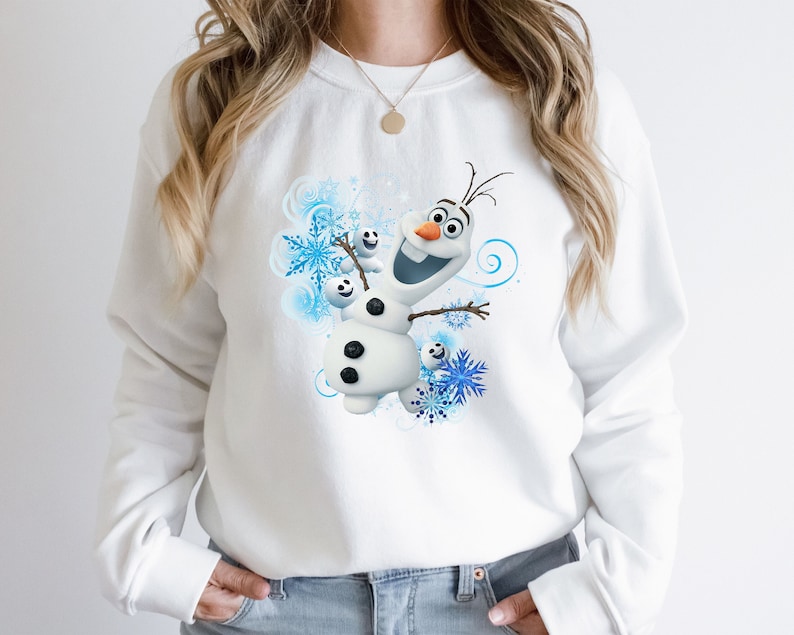 May include: White sweatshirt with a blue and white graphic of Olaf from the movie Frozen. Olaf is smiling and has his arms outstretched.