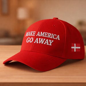 May include: A red baseball cap with the phrase "MAKE AMERICA GO AWAY" embroidered in white. The cap features a curved brim and a small flag on the side. The cap is sitting on a wooden surface.