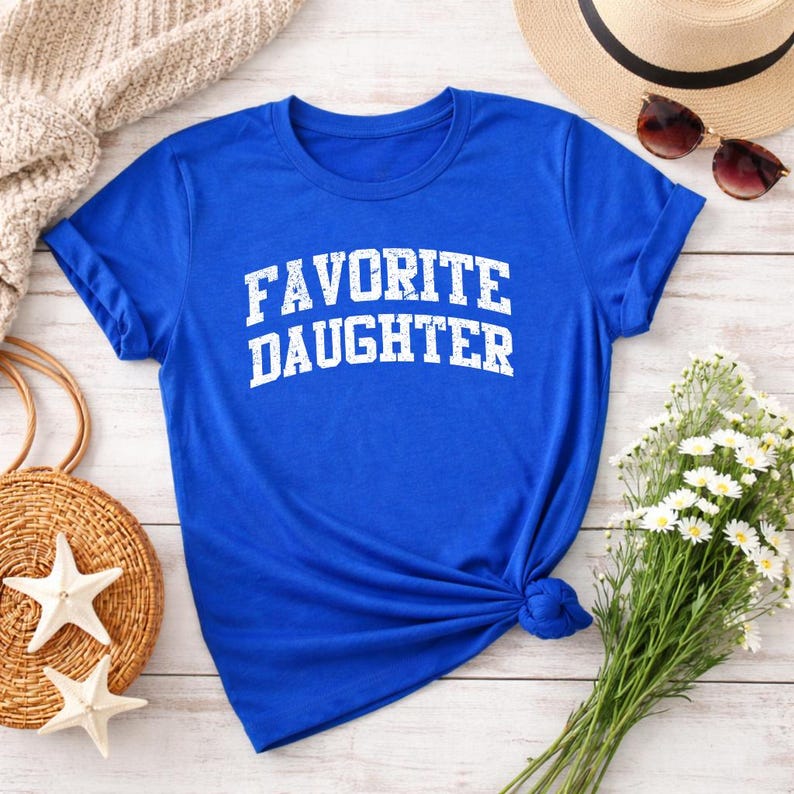 May include: A set of three ceramic mugs with a speckled, matte finish. The mugs are in cream, light grey, and dark grey. Each mug has a simple, minimalist design and a rounded handle.