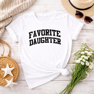 May include: A distressed wooden sign with the words "Welcome to our home" in white lettering. The sign has a rustic finish, ideal for adding a welcoming touch to any home's entrance.