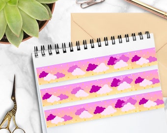 May include: Three strips of washi tape with a repeating pattern of pink and purple clouds on a yellow background with gold glitter.