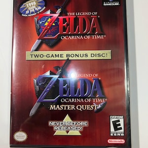 May include: A Nintendo GameCube game case for "The Legend of Zelda: Ocarina of Time" and "Master Quest." The case is red with the game title in white and gold, and features the Nintendo GameCube logo.