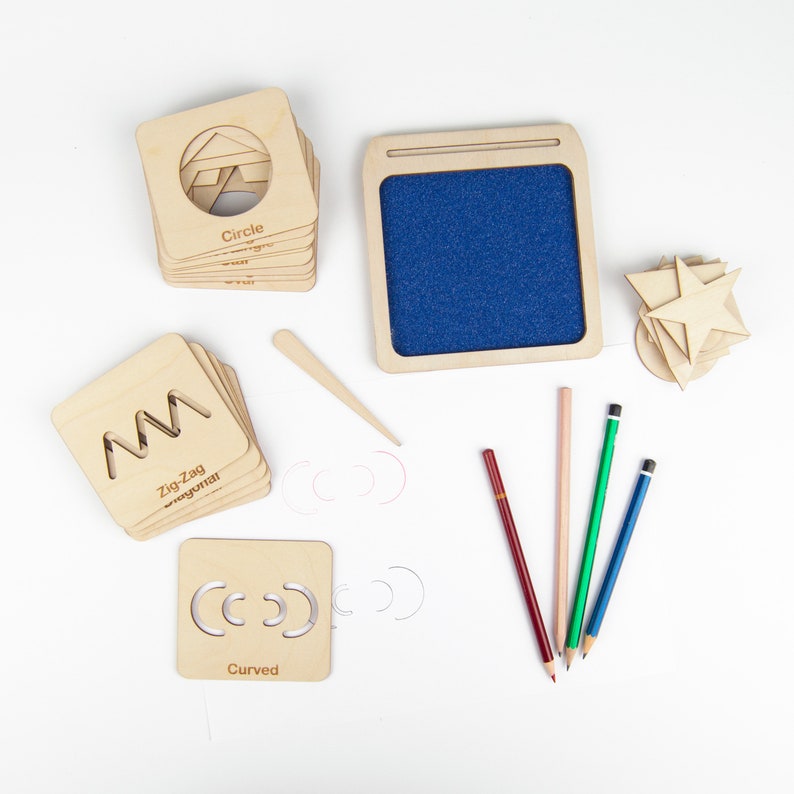 May include: Wooden tracing stencils for kids, featuring shapes like circle, zig-zag, and curved. The set includes a small wooden tray with a blue felt surface, a wooden stylus, and four colored pencils.