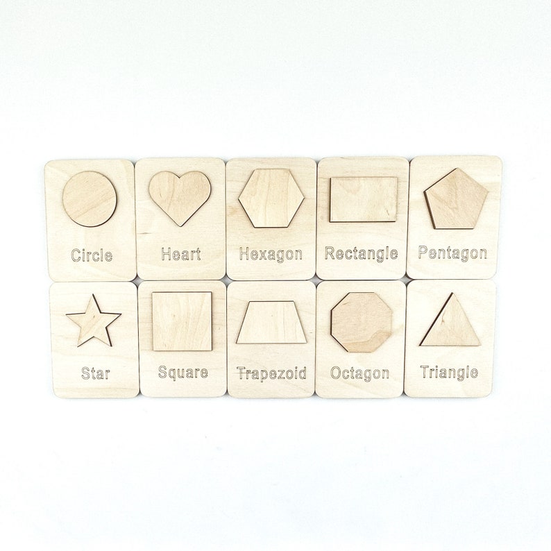 May include: Wooden cards with different shapes, including a circle, heart, hexagon, rectangle, pentagon, star, square, trapezoid, octagon, and triangle. Each card has the name of the shape written below it.