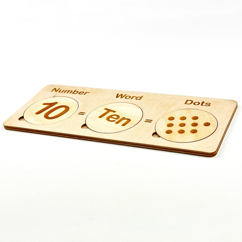 May include: Wooden learning tool with three sections labeled "Number", "Word", and "Dots". The number section shows the number "10", the word section shows the word "Ten", and the dots section shows ten dots.