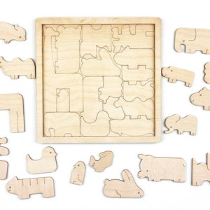 May include: Wooden puzzle with various animal shapes, including a giraffe, elephant, rhino, hippopotamus, and a bird. The pieces are arranged around a wooden frame with cutouts for each animal.