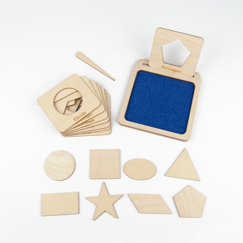 May include: Wooden shape stamps with a blue felt pad for stamping. The shapes include a circle, triangle, square, star, oval, rhombus, pentagon, and rectangle. The stamps are labeled with the name of each shape.