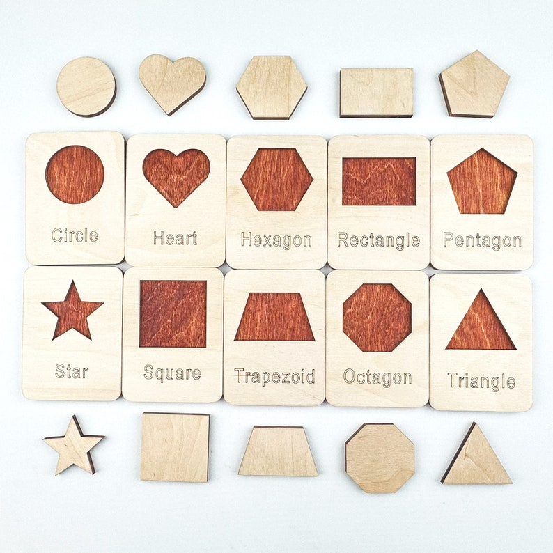 May include: Wooden shape puzzle with 10 different shapes: circle, heart, hexagon, rectangle, pentagon, star, square, trapezoid, octagon, and triangle. Each shape has a cutout and a corresponding piece to fit inside.