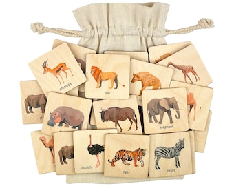 May include: A set of wooden animal flashcards in a burlap drawstring bag. The cards feature illustrations of animals like a lion, elephant, zebra, tiger, ostrich, antelope, and more.