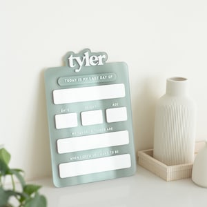 May include: A light blue acrylic growth chart with the name "tyler" at the top. The chart has spaces to fill in the date, height, age, favorite things, and what the person wants to be when they grow up.
