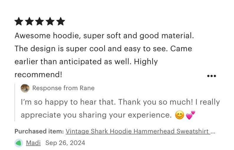 May include: Five star review for a vintage shark hoodie sweatshirt. The review states that the hoodie is super soft and the design is cool and easy to see. The reviewer also states that the hoodie arrived earlier than expected.