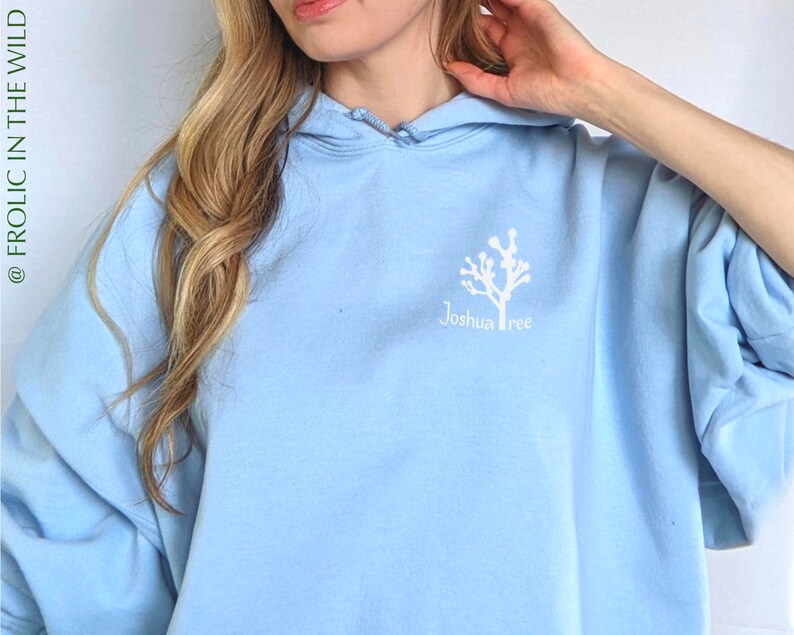 May include: A light blue hoodie with a white graphic of a Joshua Tree and the text "Joshua Tree" on the front.