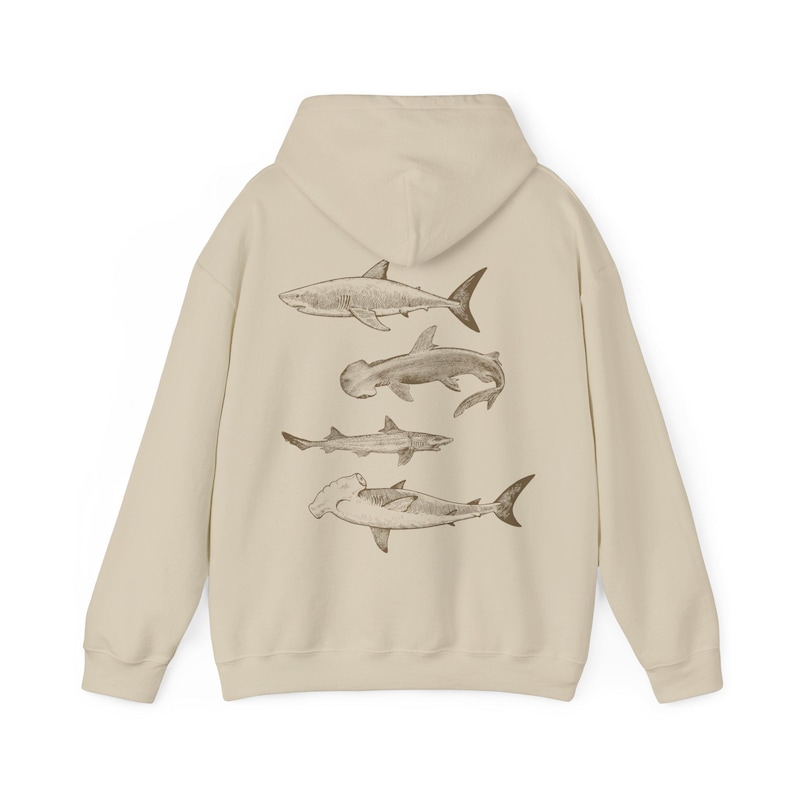May include: A beige hoodie with a graphic print of four different types of sharks on the back.