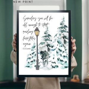 Może przedstawiać: Oprawiony wydruk z akwarelową ilustracją ośnieżonych sosen i latarni. Wydruk zawiera cytat "Someday you will be old enough to start reading fairytales again" autorstwa C.S. Lewisa. U góry widnieje napis "NEW PRINT".