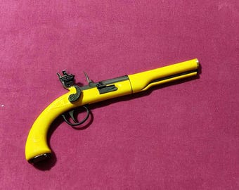 Könnte beinhalten: Eine gelbe Spielzeugpistole mit schwarzen Akzenten. Die Pistole hat einen Lauf, einen Griff und einen Abzug.