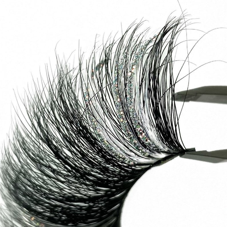 3D Mink Silver Glitter Sparkles Strip Lashes With Long White Eyelashes. 2 Tone White Color Strip Lashes. Black Eyelashes With White Lashes And Silver Glitter. Fluffy Volume 25mm. Trending Color Lash Extensions For Lash Lovers.