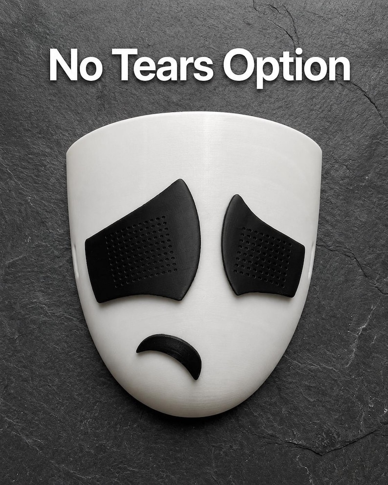 May include: A white mask with black eye coverings and a curved black mouth, with the text "No Tears Option" above. The mask has a sad expression.