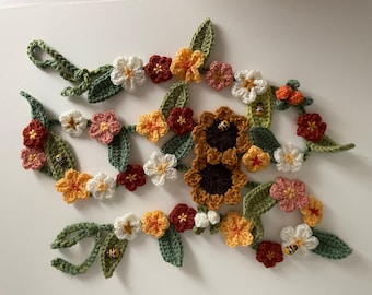 A Spring crochet garland. A unique and handmade item decorated with bees- could be used to decorate a wedding such as the top table flowers.