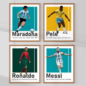 May include: Four framed art prints featuring iconic football players: Maradona, Pele, Ronaldo, and Messi. Each print shows a player in action with their name and achievements. The prints have a wooden frame and a colourful background.