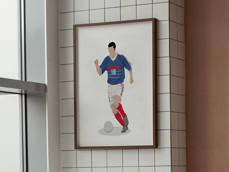 May include: A framed illustration of a soccer player in a blue and white jersey with the number 10 on the front, dribbling a soccer ball. The player is wearing red socks and black cleats.