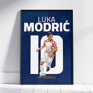 May include: A poster featuring Luka Modric, a Croatian soccer player, wearing a red and white jersey with the number 10. The background is blue with the text "Luka Modric" and the number 10 in white.