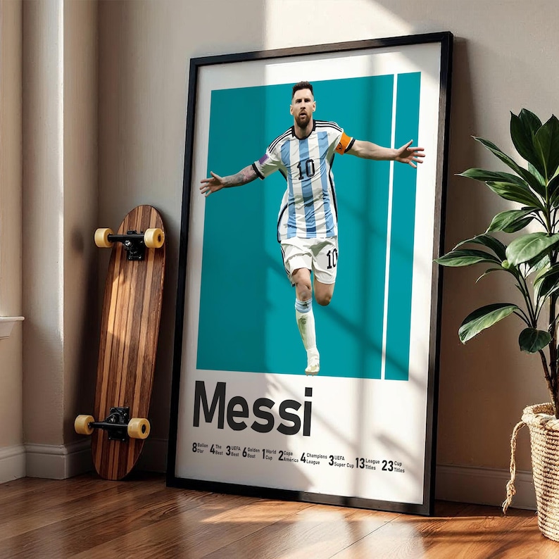 May include: Framed poster featuring a soccer player in a blue and white striped jersey, arms outstretched. The poster has the name "Messi" at the bottom, with a teal background and white vertical stripes. A wooden skateboard leans against the wall.