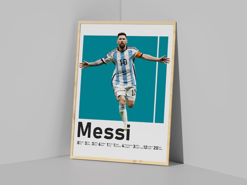 May include: Framed poster featuring footballer Lionel Messi in his Argentina national team kit. The poster has a teal background with the name "Messi" and his achievements listed below.