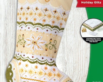 May include: A cream-colored felt stocking kit with the name "Lily" embroidered in gold. The stocking is decorated with white, green, and gold embellishments, including sequins and beads. The kit includes stamped felt, floss, sequins, beads, and instructions. The stocking measures 18 inches (45.7 cm).