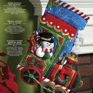 May include: A felt Christmas stocking kit, featuring a train design with a snowman, candy canes, and the name "Ryan". The stocking is 18 inches long and includes stamped felts, sequins, beads, and instructions.