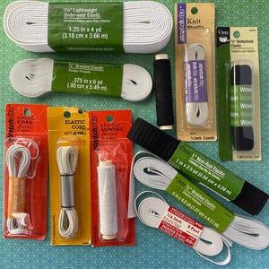 May include: Assortment of elastic and cord for sewing projects.  The elastic comes in various widths and colors, including white, black, and beige.  The cord is white and comes in a spool.  The packaging includes labels with measurements in inches and centimeters.