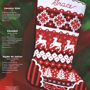 May include: A red and white felt Christmas stocking kit by Bucilla featuring the name Grace embroidered at the top. The design includes white reindeer, pine trees, and geometric patterns with sequins and beads. It measures 18 inches in length.