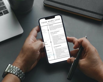 May include: A person is reviewing a resume on a smartphone. The resume is formatted with a black and white color scheme and includes sections for "Profile", "Work Experience", and "Skills". The text on the resume reads "Your Name Here", "Graphic Designer", and "Your Job Position Here".