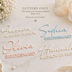 May include: Four sets of personalized acrylic letters in white, light blue, and soft pink. The text reads Jessica Maid of Honor, Sophia Bridesmaid, Olivia Bridesmaid, and Hannah Matron of Honor. The text Letters Only is printed at the top.
