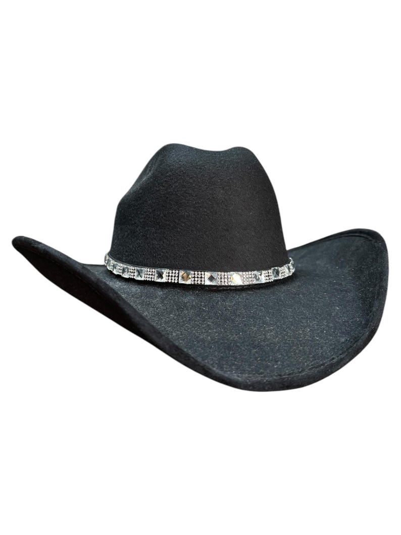 May include: A black felt cowboy hat with a silver rhinestone band.