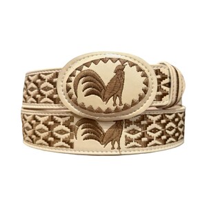 May include: A cream-colored belt featuring a large oval buckle with an embroidered brown rooster design. The belt strap is decorated with a repeating geometric pattern in brown thread, matching the rooster motif on the central oval buckle.