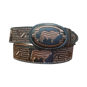 May include: A dark brown leather belt featuring an oval buckle with an embroidered bull design. The belt strap is decorated with a repeating geometric pattern and additional bull motifs in light brown thread, complemented by white stitching.