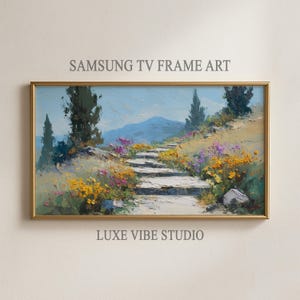 Könnte beinhalten: Gerahmtes Landschaftsgemälde mit goldenem Rahmen. Das Kunstwerk zeigt einen Steinweg, der einen Hügel hinaufsteigt, gesäumt von bunten Wildblumen. Der Himmel ist blau, und der Text "SAMSUNG TV FRAME ART" und "LUXE VIBE STUDIO" sind sichtbar.
