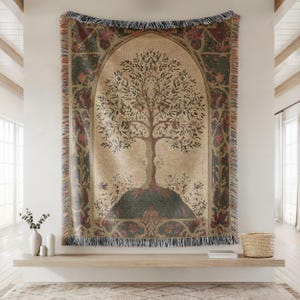 Peut inclure: Une tapisserie tiss&eacute;e avec un motif d'arbre sur fond beige, bord&eacute;e de vert fonc&eacute; et de bordeaux. L'arbre pr&eacute;sente un tronc et des branches d&eacute;taill&eacute;s avec des feuilles. La tapisserie rectangulaire a une bordure &agrave; franges.