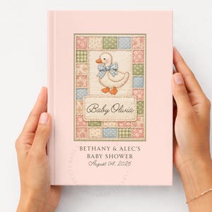 May include: A pink baby shower guest book with a patchwork design and a duck illustration. The cover features the text "Baby Olivia" and "Bethany & Alec's Baby Shower August 04, 2026".