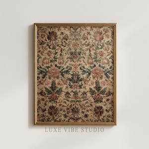 May include: A framed print featuring a detailed floral pattern in shades of beige, pink, green, and burgundy. The artwork has a vintage aesthetic, with a gold-colored frame. The text "LUXE VIBE STUDIO" is visible at the bottom.