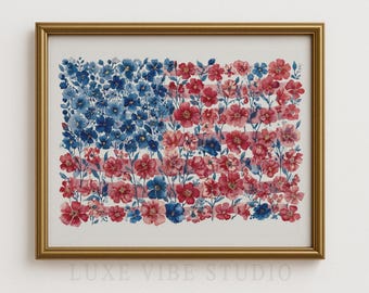 May include: A framed watercolor painting of the American flag, composed of red, white, and blue flowers. The artwork is in a gold frame and features the text "LUXE VIBE STUDIO" at the bottom.