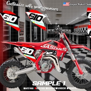 May include: A red GasGas dirt bike with black and white graphics. The bike has a number plate with the number 610 on it. The bike is in a showroom setting with a checkered floor.