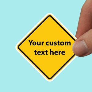 May include: A yellow diamond-shaped sign with a white border and the text "Your custom text here".